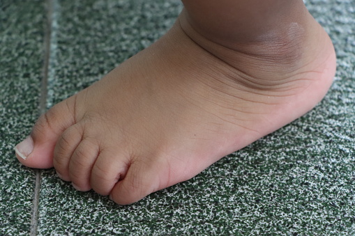 Baby foot on the floor, childcare concept, toddler development