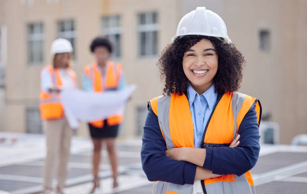 istock Construction worker, woman with smile in portrait and builder at work site with engineering and architecture. Happy female contractor in helmet, building industry and infrastructure with arms crossed 1560555698