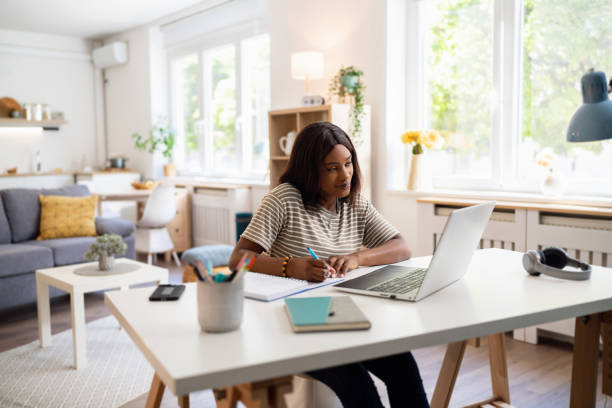 istock Young female student of Black ethnicity e-learning 1560556804