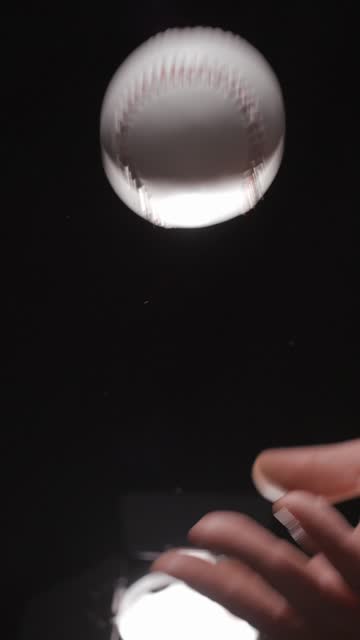 Baseball ball in studio close-up, macro, with smoke 4K, vertical slow-motion