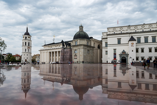 Vilnius, Lithuania - July 05, 2018: Vilnius Cathedral Square with Bell Tower, Cathedral and The Palace of the Grand Dukes of Lithuania with Reflection.
