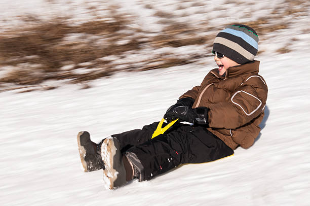 istock Young Boy Palying Sliding on Snow 156058548