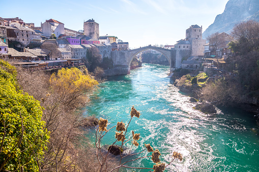 Mostar,  Herzegovina - January 15, 2023: Visitors of the Old town of Mostar crossing the Old bridge (\