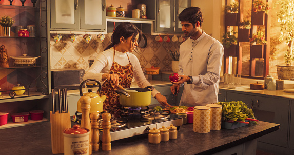 Gorgeous Young Indian Couple Preparing Food Together: Celebrating Family Recipes, Connecting Emotionally and Spending Family Time Together. Young People Having Fun.