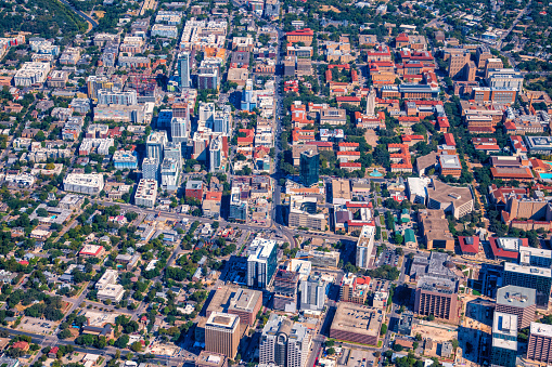 Aerial view of the beautiful campus of the University of Texas in the city of Austin from about 2000 feet in altitude during a helicopter photo flight.  The campus buildings are easy to spot having the red tile roofs.