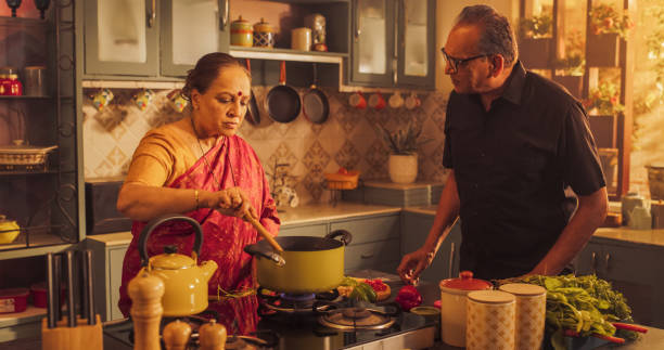 istock Indian Couple Exploring Traditional Cooking: Preserving Culinary Heritage, Preparing Authentic Recipes with Love and Care. Sharing Love and Tenderness in the Kitchen. 1560607910