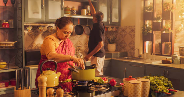 istock Indian Couple Exploring Traditional Cooking: Preserving Culinary Heritage, Preparing Authentic Recipes with Love and Care. Sharing Cultural Traditions in the Kitchen. 1560607931