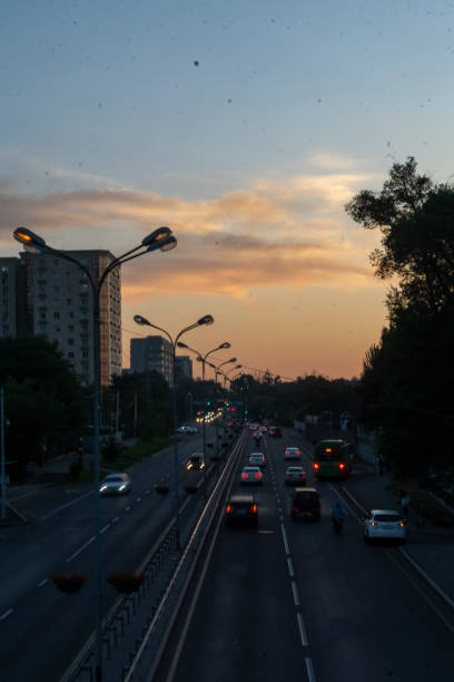 istock traffic image with the red of the sunset reflected in the sky 1560612247