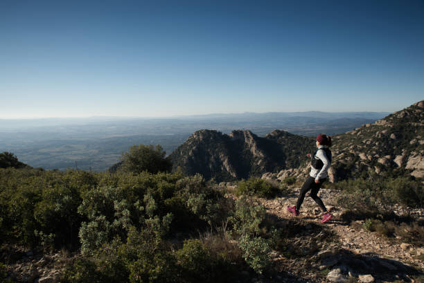 istock Woman athlete running through the mountains. 1560615267
