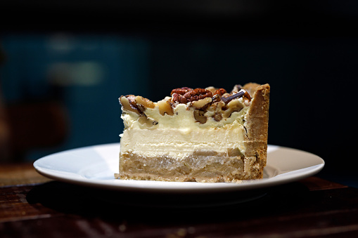 salted caramel apple cheese cake with biscuit crust, home-made caramelised apple filling, baked cheese cake, whipped cream, salted caramel roasted pecans and walnuts.