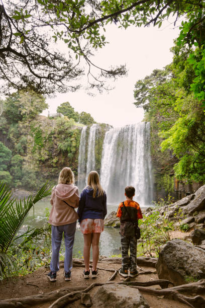 Mum and children looking at Waterfall stock photo