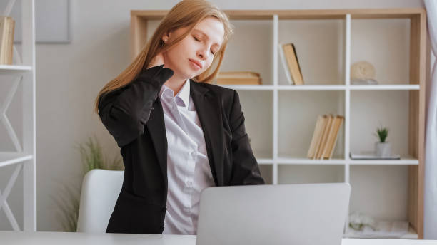 istock Computer tiredness neck pain office woman rubbing 1560632562