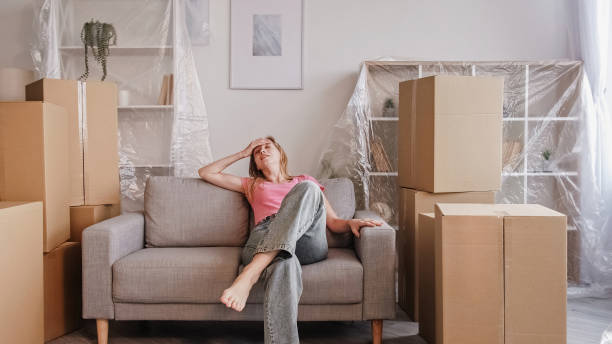istock Relocation day packing tiredness woman resting 1560632565
