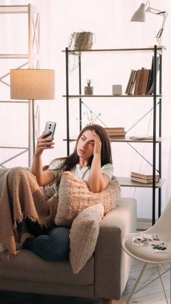 istock Home appointment call girl smartphone medicines 1560633083