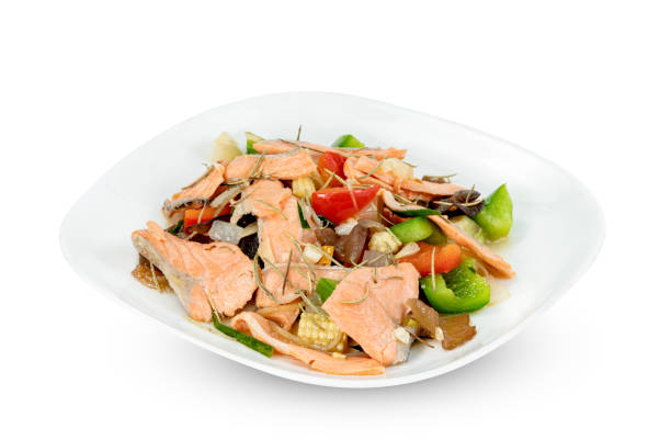 stir fried salmon with sweet bell pepper on dish isolated on white background ,include clipping path