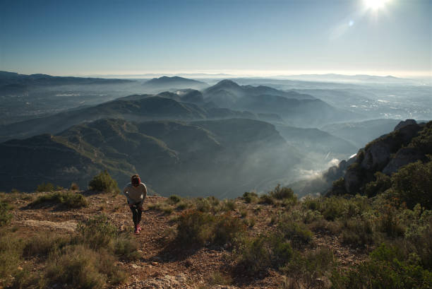 istock Woman trains in the mountains. 1560647296
