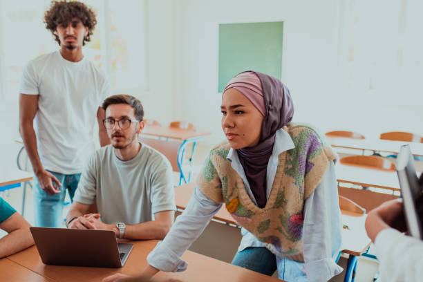 istock A diverse group of students gathers in a modern school classroom, passionately engaging in lively discussions about various projects, embracing teamwork and utilizing technology to enhance their learning experience 1560650748
