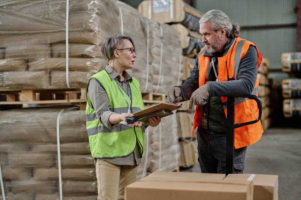 istock Manager talking to worker in factory 1560664047