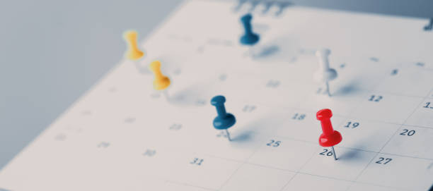 istock Embroidered red pins on a calendar event Planner calendar,clock to set timetable organize schedule,planning for business meeting or travel planning concept. 1560667866
