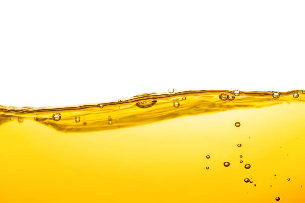 istock Oil wave background, yellow liquid, and bubbles on white background. 1560670561