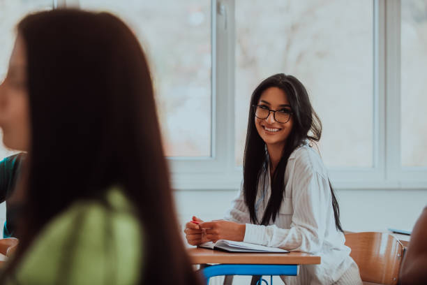 istock A black-haired female student wearing glasses is attentively engaged in a modern classroom, embracing education and learning with focus and curiosity 1560672143