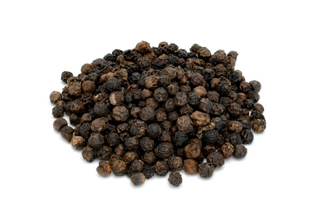 istock Black pepper pile or Black peppercorns seeds isolated on white background. 1560672226