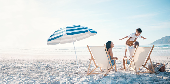 Couple in loungers on a tropical beach at Maldives