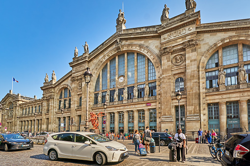 Paris, France - July  10, 2023: Traffic and pedestrians in front of the North train station in Paris.