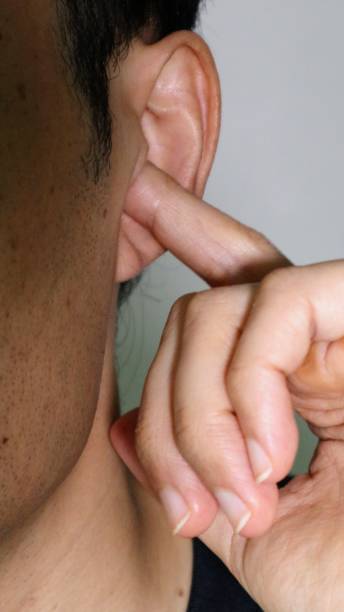 istock Close-up of a man scratching his ear 1560710734
