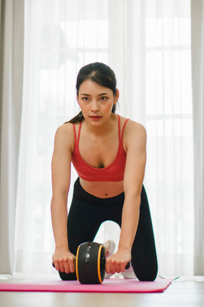 istock Home Fitness Journey: Beautiful Asian Woman Exercising 1560725705