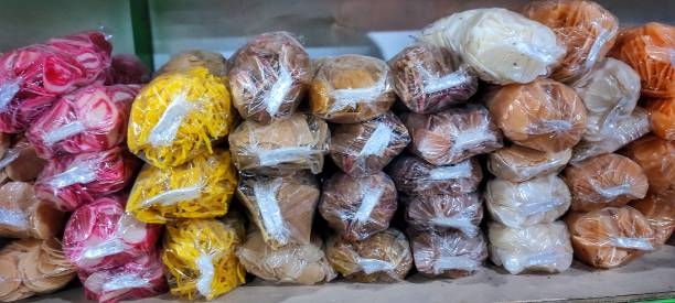 istock Piles of raw crackers wrapped in plastic are arranged on a shelf 1560728105