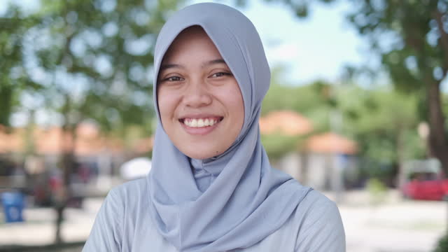 Cheerful Young Muslim Indonesian Woman Looking at Camera