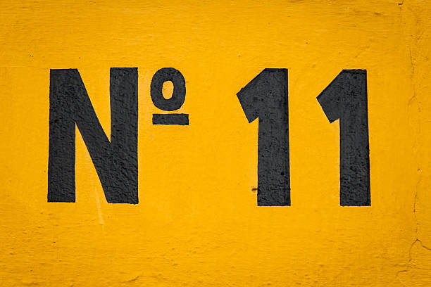 istock Black image of the number 11 on orange background 156074416