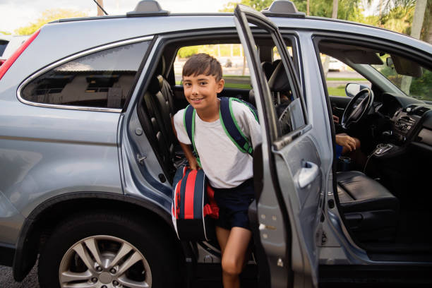 Morning routine for young boy riding to school in car.