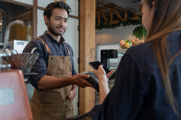 istock Woman use smartphone to scan QR code to pay in cafe restaurant with a digital payment without cash. Choose menu and order accumulate discount. E wallet, technology, pay online, credit card, bank app. 1560750807