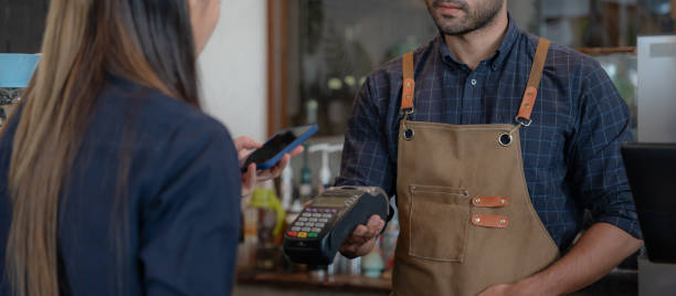 istock Woman use smartphone to scan QR code to pay in cafe restaurant with a digital payment without cash. Choose menu and order accumulate discount. E wallet, technology, pay online, credit card, bank app. 1560750808