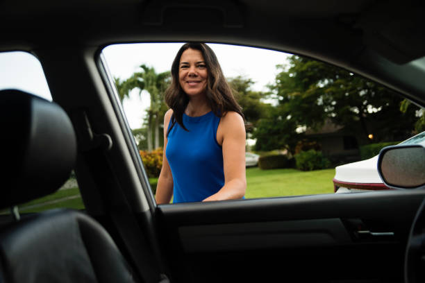 istock Morning routine for mature woman getting in car. 1560751911