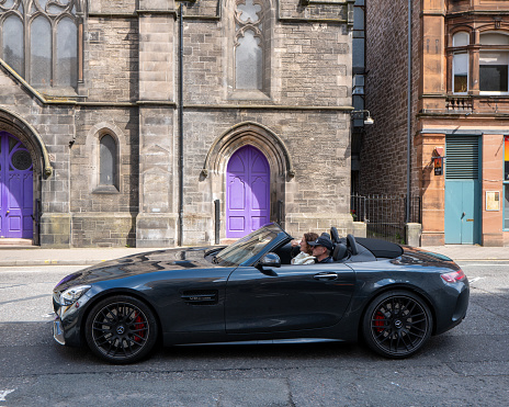 20 July 2023. Inverness,Highlands and Islands,Scotland. This is a Mercedes sports car - V8 Biturbo in Inverness City with the soft top down.