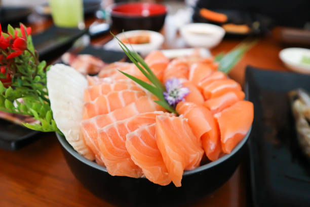 istock raw salmon, sashimi or sliced salmon and grilled squid 1560776257