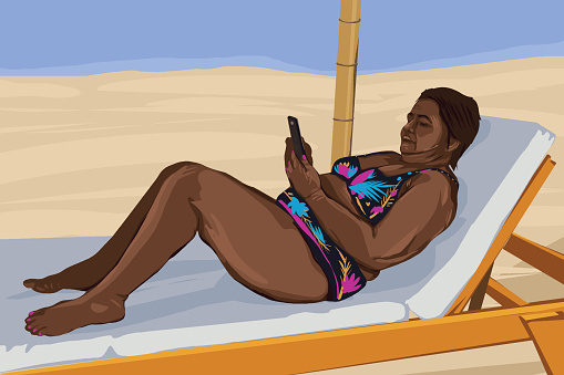 Middle aged woman lying at the beach and having some time off to read the news
