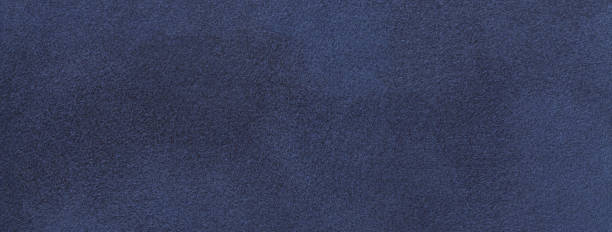 istock Texture of velvet matte navy blue background, macro. Suede denim fabric with pattern. Seamless textile felt backdrop 1560835826