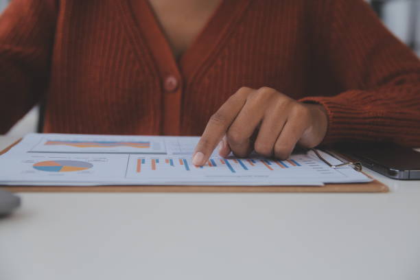 istock Asian Businesswoman Using laptop computer and working at office with calculator document on desk, doing planning analyzing the financial report, business plan investment, finance analysis concept. 1560836362