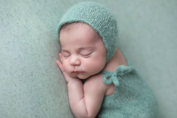 istock Newborn baby girl sleeping 1560875076