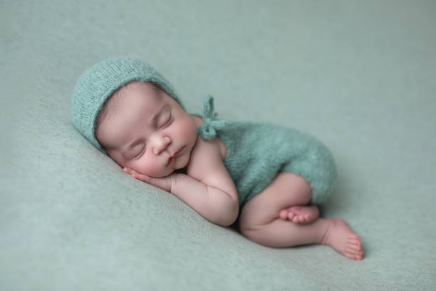 istock Newborn baby girl sleeping 1560875077
