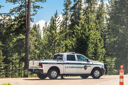 Yellowstone National Park, USA - June 21, 2023: Yellowstone National Park service ranger vehicle sitting to the side of the road.