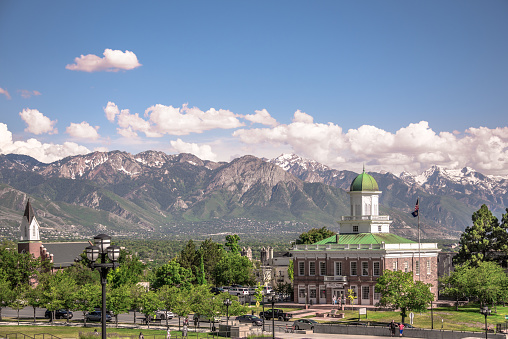 Salt Lake City, USA - June 16, 2023: View of Salt Lake City Council Hall with Wasatch mountain range in the background.