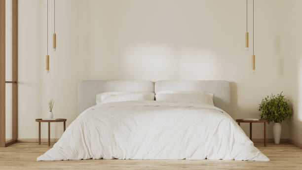 istock Bedroom interior with big white bed, sunlight on wall, bedside tables with pendant light, 3d render 1560938512