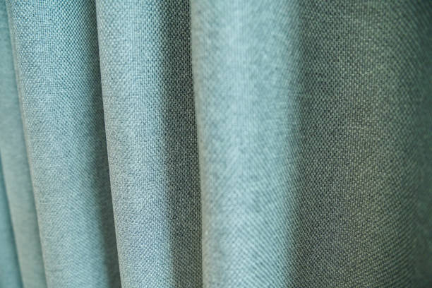 istock Green blackout fabric with burlap texture, light-blocking fabric on window 1560945504