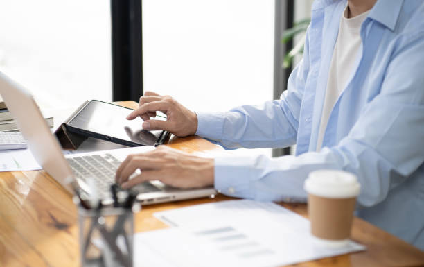 istock Asian businessman  In the Data Mining Center Statistician with Monitors Displaying business finance technology and investment. Stock Market Investments 1560977736