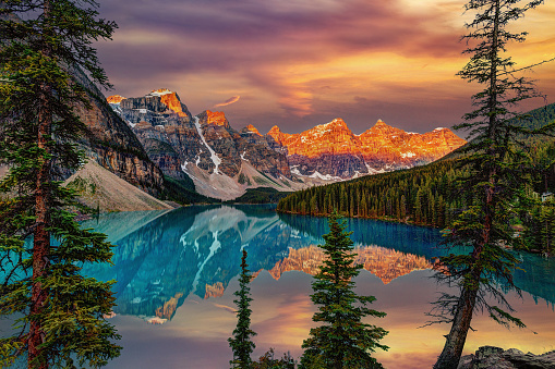 Golden sunrise over the Valley of the Ten Peaks with glacier-fed, turquoise-colored Moraine Lake in the foreground near Lake Louise in the Canadian Rockies of Banff National Park. HDR rendering.